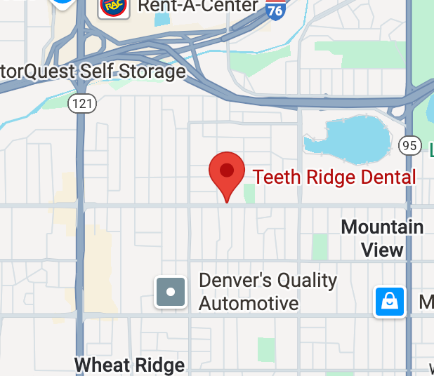 Map with a red pin marking Teeth Ridge Dental in a suburban area; nearby Denver's Quality Automotive and Wheat Ridge in view, with major roads around.