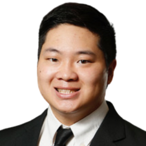Smiling Asian man in a black suit and tie, head-and-shoulders portrait against a white background.